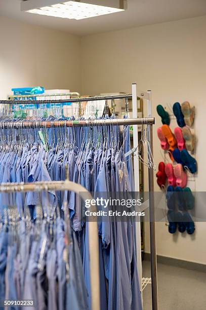 operating room shoes and scrubs in hospital - medical scrubs hanger stock pictures, royalty-free photos & images