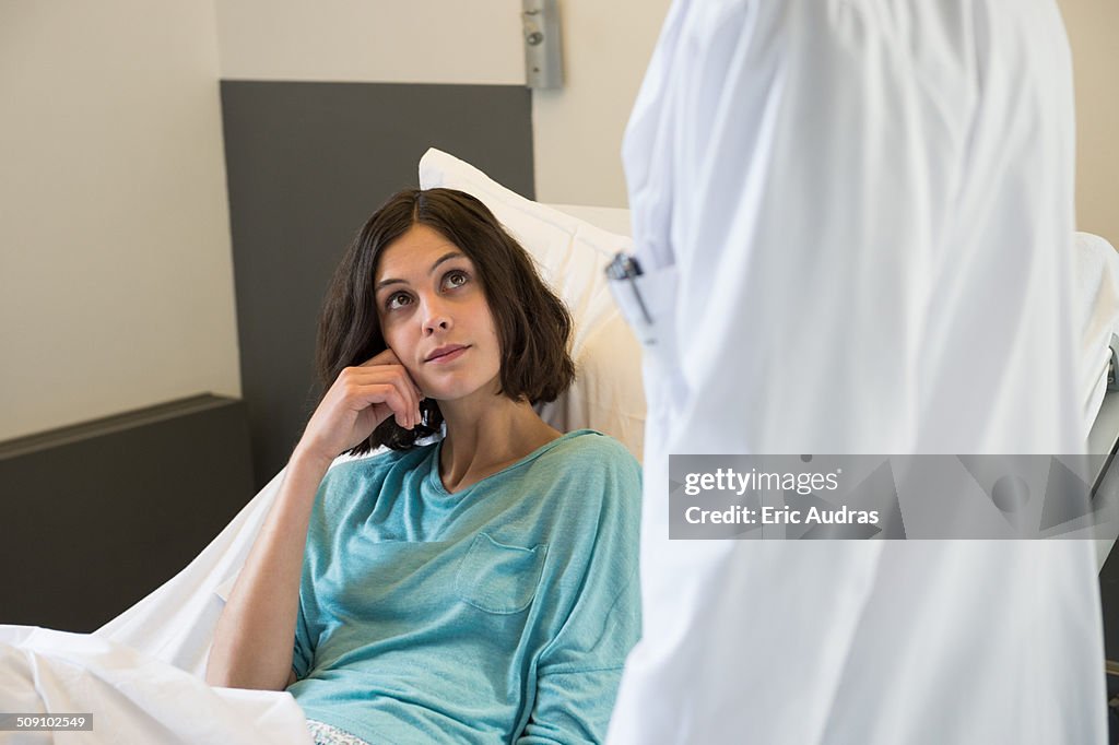 Male doctor attending a patient in a hospital