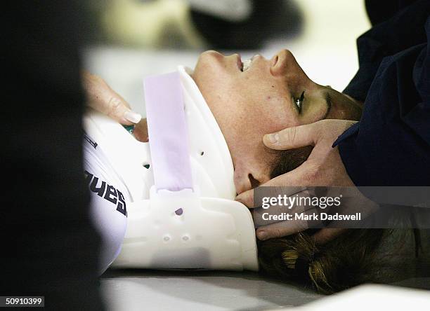 Rochelle Gilmore of Australia receives medical attention after falling in the Women's Scratch race during the 2004 UCI Track Cycling World...