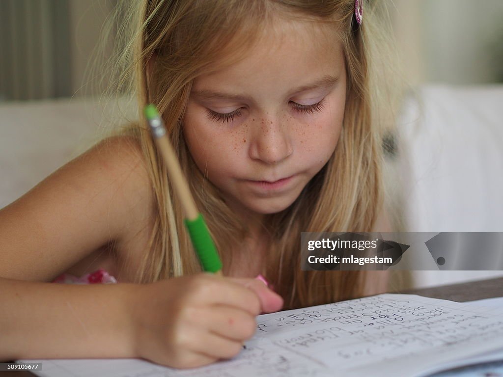 Sweden, Girl (8-9) writing in note book