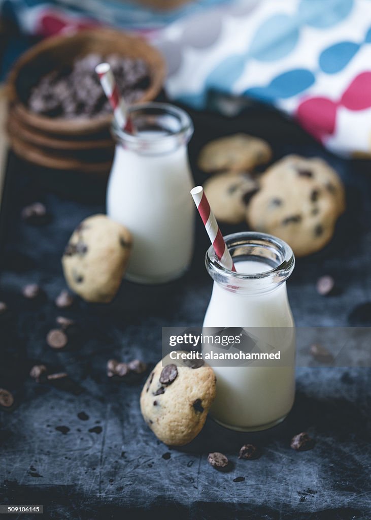 Chocolate chip cookies and milk bottles