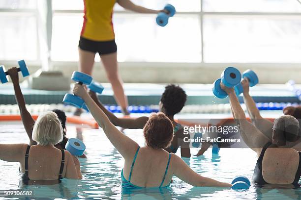 leading a water aerobics class - leisure activity stock pictures, royalty-free photos & images