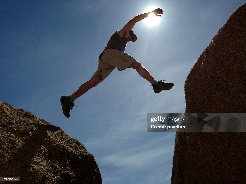 Man jumping between rocks