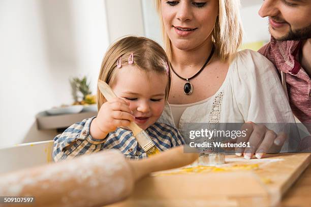 family baking in kitchen at home - gluten free bread stockfoto's en -beelden