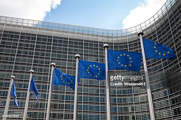 belgium, brussels, european commission, european flags at berlaymont building - european commission stock-fotos und bilder