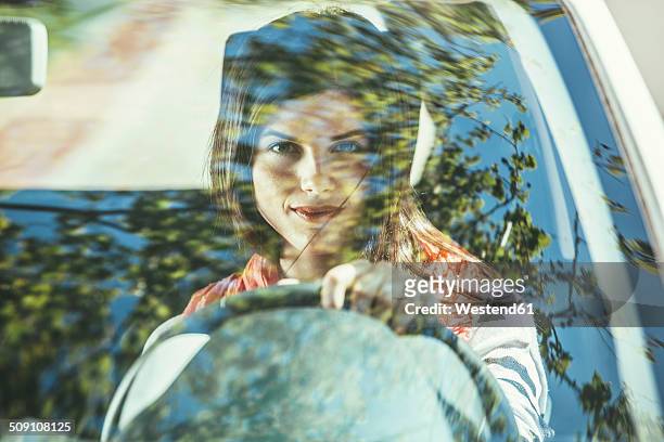 spain, barcelona, young woman in car - windschutzscheibe stock-fotos und bilder