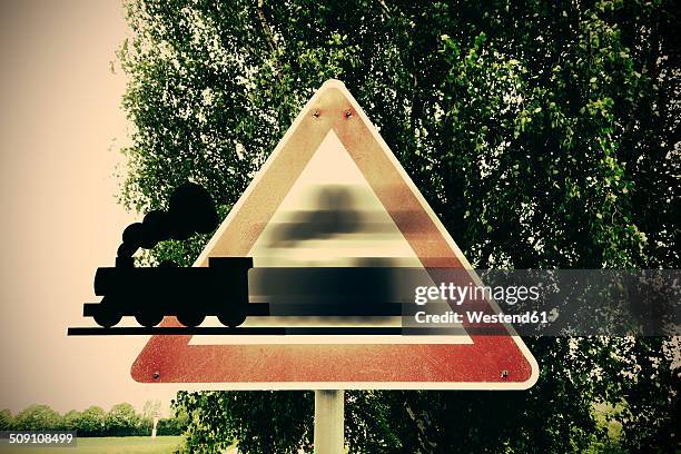 germany, road signs, train coming aout of warning sign - lokomotive stock-fotos und bilder