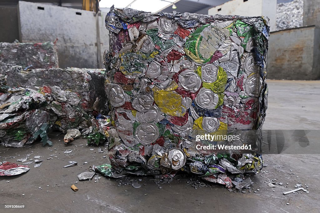 Compressed cans in a scrap metal recycling plant