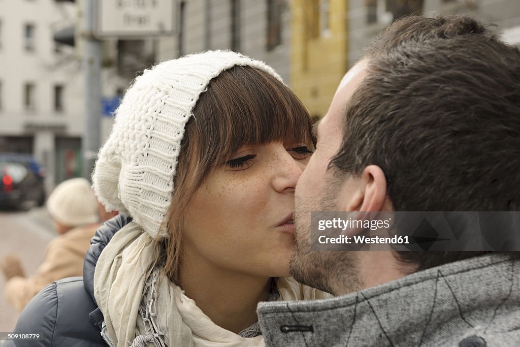 Portrait of kissing young couple in winter