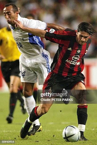Marco Borriello of AC Milan beats Ailton De Araujo of Hong Kong side Kitchee in their exhibition game at Hong Kong Stadium, 30 May 2004. The score...
