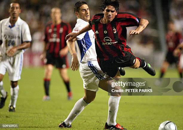 Marco Borriello of AC Milan is fouled by Nisa Saveljic of Hong Kong side Kitchee in their exhibition football match at Hong Kong Stadium, 30 May...