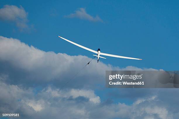 glider at start in front of clouds - glider stock pictures, royalty-free photos & images