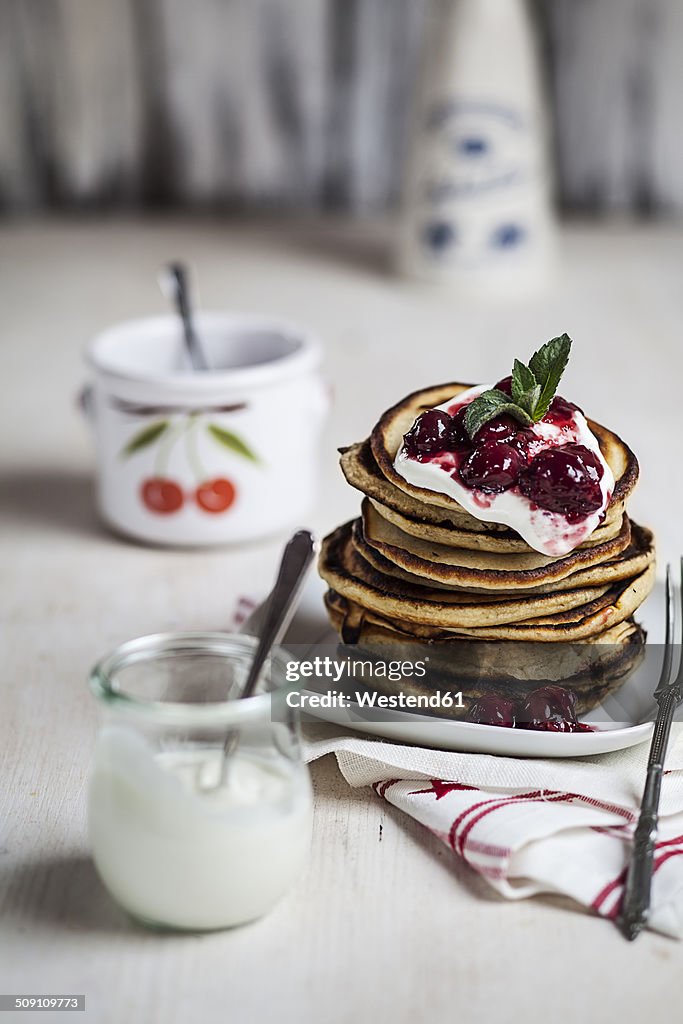 American pancakes with cherry sauce and greek yogurt