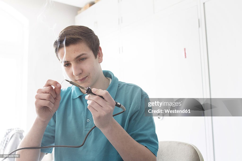 Electronic apprentice with soldering iron and wire