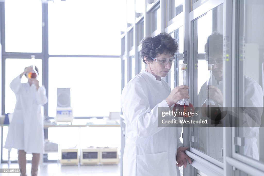 Two female chemists working in lab