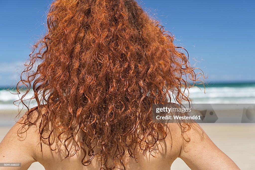 Australia, New South Wales, Broken Bay, red-haired woman looking at sea, back view