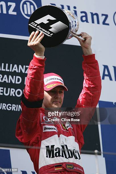 Michael Schumacher of Germany and Ferrari displays a somber mood on the podium due to the death of Fiat president Gianni Angelli after winning the...