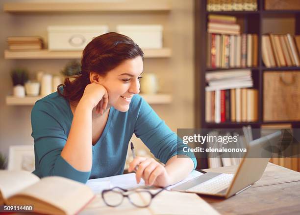 beautiful young woman working at home - students working on pc school stock pictures, royalty-free photos & images