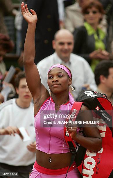 Serena Williams waves after winning against Japanese Shinobu Asagoe in the fourth round of the French Open at Roland Garros in Paris 30 May 2004. AFP...