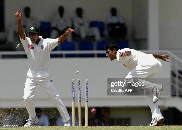 Bangladesh bowler Tareq Khan runs out West Indies opening batsman Devon Smith for 0 as Mohammed Ashraful celebrates on the third day of the first...