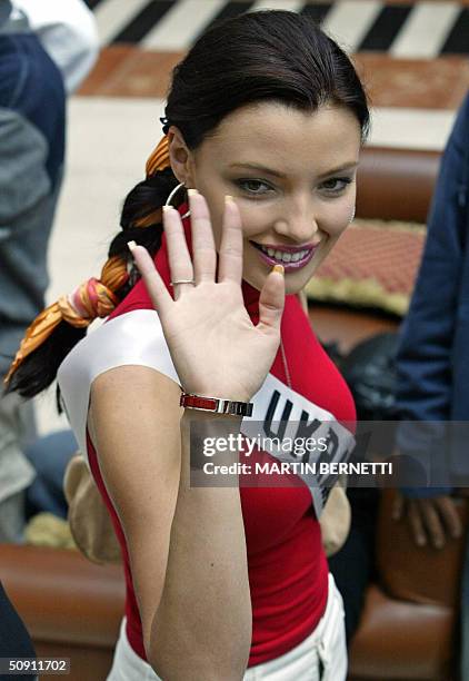 Miss Ukraine Oleksandra Nikolayenko waves at photographers as she walks across the hotel hall 30 May 2004, in Quito, Ecuador, where the Miss Universe...