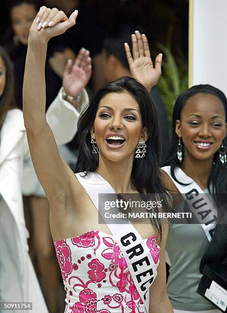 Miss Greece Valia Kakouti and Miss Guatemala Marva Weatherborn wave to photographers 30 May 2004, in Quito, Ecuador, where the Miss Universe 2004...
