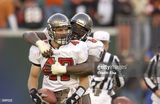 John Lynch of the Tampa Bay Buccaneers is congratulated by teammate Warren Sapp , after recovering a fumble , which set up the winning field goal...
