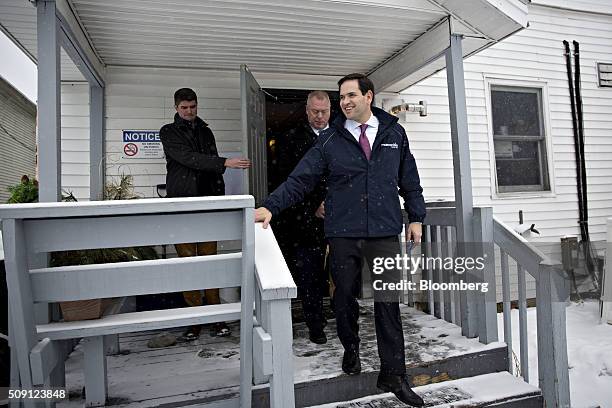 Senator Marco Rubio, a Republican from Florida and 2016 presidential candidate, center, leaves following a campaign stop at the Village Trestle...