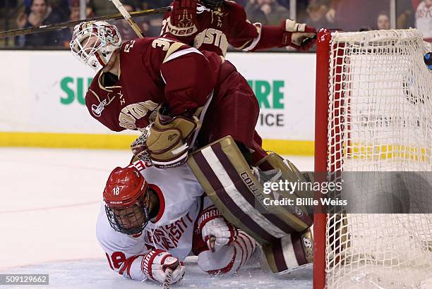 Jordan Greenway of Boston University runs into Thatcher Demko of Boston College during the third period of the Beanpot Tournament championship game...