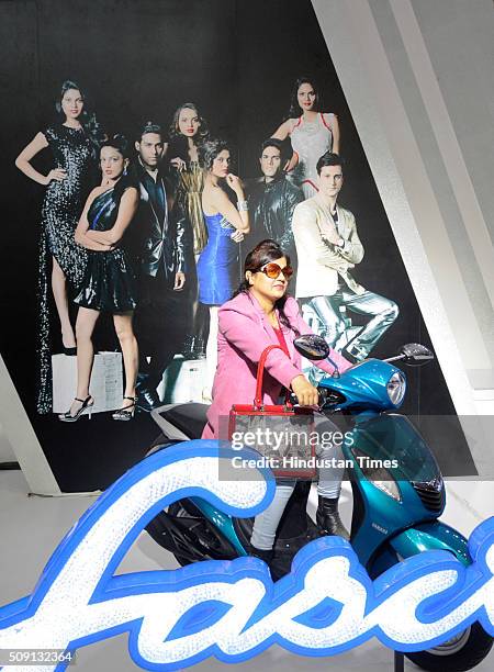 Visitor poses with Yamaha Fascino showcased at the Auto Expo 2016 on February 8, 2016 in Greater Noida, India. People thronged at the Auto Expo 2016...