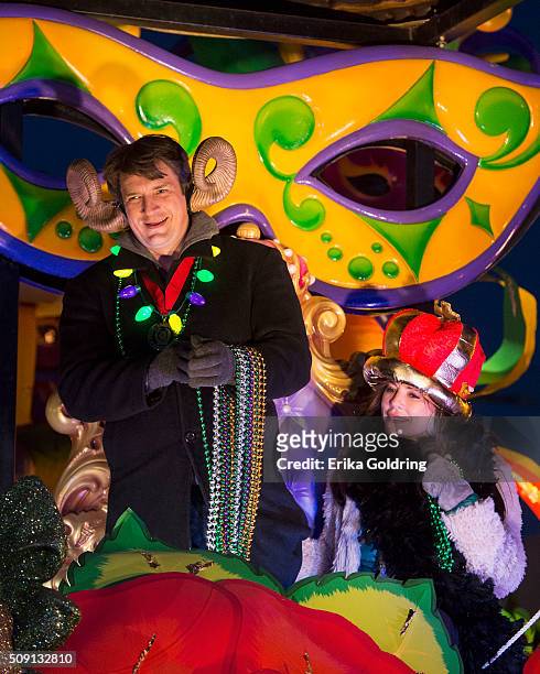 Actors Nathan Fillion and Krista Allen ride in the Krewe of Orpheus parade on February 8, 2016 in New Orleans, Louisiana.