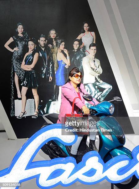 Visitor poses with Yamaha Fascino showcased at the Auto Expo 2016 on February 8, 2016 in Greater Noida, India. People thronged at the Auto Expo 2016...