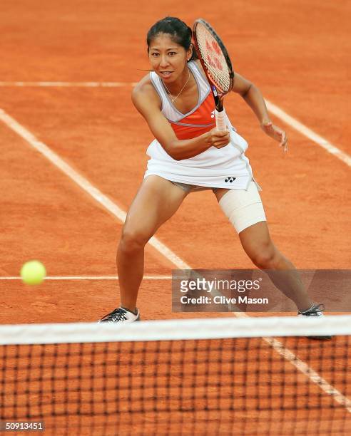 Shinobu Asagoe of Japan returns in her fourth round doubles match with Rika Fujiwara of Japan during Day Eight of the 2004 French Open Tennis...