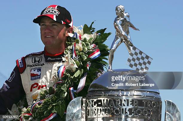 Buddy Rice driver of the Rahal-Letterman Argent/Pioneer G Force Honda poses with the Borg Warner Trophy on the day after winning the 88th running of...