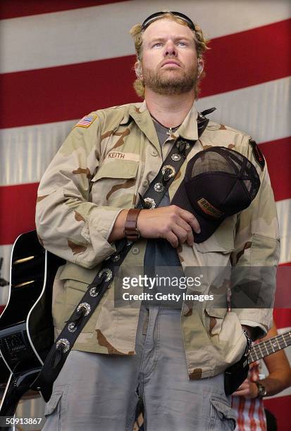 In this handout photo, country music star Toby Keith holds his cap over his heart during a moment of honor during a Memorial Day performance at...