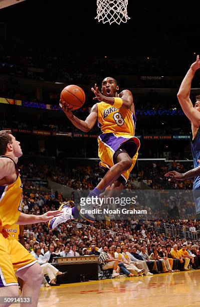 Kobe Bryant of the Los Angeles Lakers drives to the basket past the Minnesota Timberwolves defense in Game Six of the Western Conference Finals...