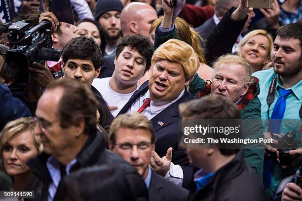 Man dressed as republican presidential candidate Donald Trump shouts to Trump as he greets supporters after speaking at a campaign rally at the...