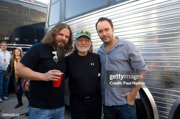 American musicians Jamey Johnson and Willie Nelson , pose with Canadian Neil Young during the Farm Aid benefit concert outside the Verizon Wireless...