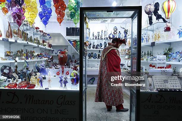 Costumed reveller browses inside a glassware store during the 2016 Carnevale di Venezia, in Venice, Italy, on Friday, Feb. 5, 2016. The annual Venice...