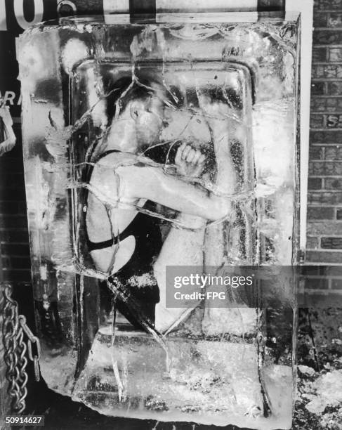 An escape artist encased in a block of ice, circa 1930.