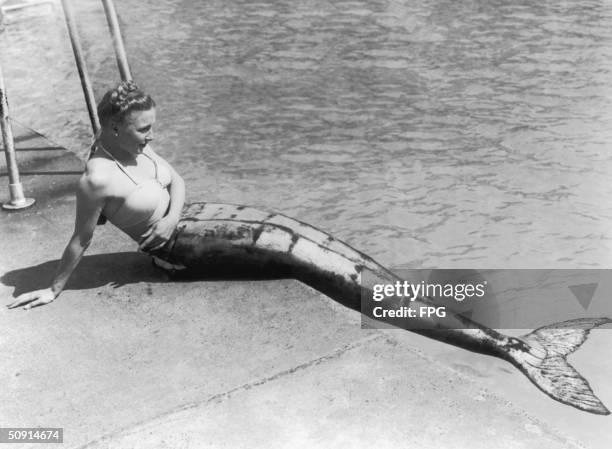 Mermaid sitting by a pool's edge in Scotland, 1949.