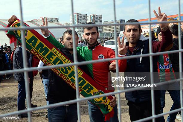 Amedspor's supporters gesture and wave scarves to cheer their team prior to the Turkish Cup football match between Amed Spor and Fenerbahce Zirrat on...