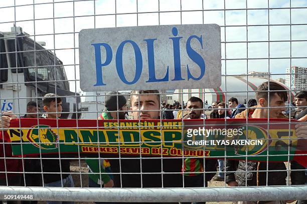 An Amedspor's supporter waves a scarf to cheer his team prior to the Turkish Cup football match between Amed Spor and Fenerbahce Zirrat on February...