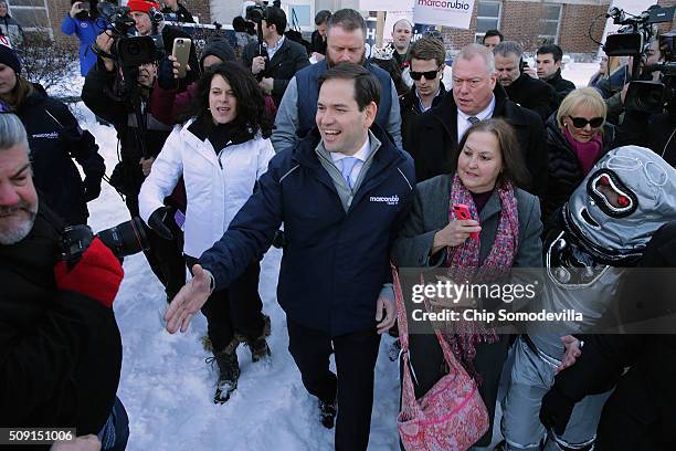Sen. Marco Rubio shakes hands while thanking supporters outside the polling place at Webster School February 9, 2016 in Manchester, New Hampshire....