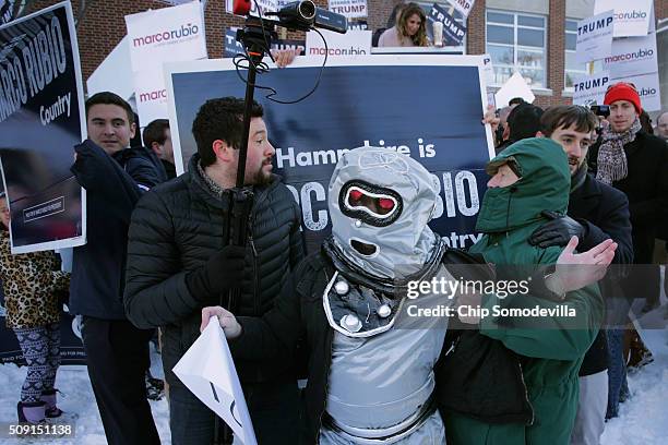 Volunteers and staff for Republican presidential candidate Sen. Marco Rubio and trackers and demonstrators dressed as robots from the American Bridge...