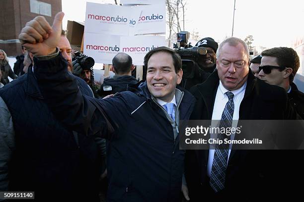 Sen. Marco Rubio boards his campaign bus after stopping to thank supporters outside the polling place outside Webster School February 9, 2016 in...