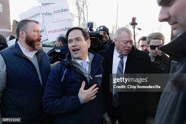 Sen. Marco Rubio boards his campaign bus after stopping to thank supporters outside the polling place outside Webster School February 9, 2016 in...