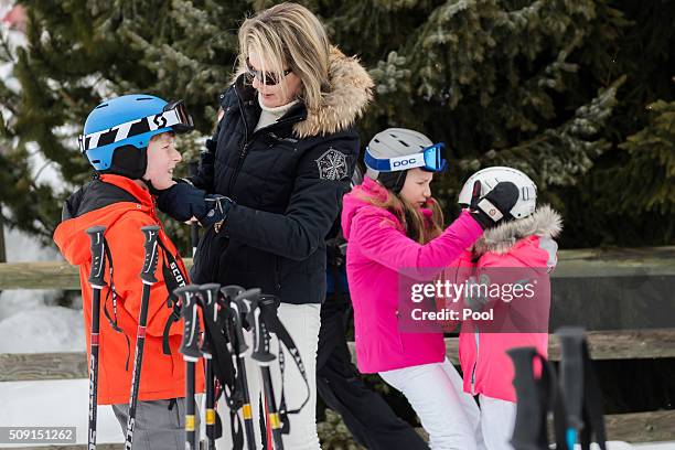 Queen Mathilde of Belgium and Princess Elisabeth, Duchess of Brabant help Prince Emmanuel of Belgium and Princess Eléonore of Belgium with their...