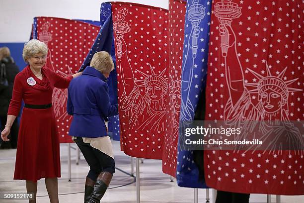 Voters head to the polling booths inside the Webster School gymnasium February 9, 2016 in Manchester, New Hampshire. Tuesday is the 100th anniversary...