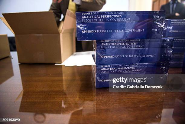 Congressional aids unpack boxes of the President's Fiscal Year 2017 Budget to the House Budget Committee Room in the Cannon House Office Building on...